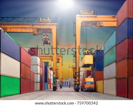 The RTG(Rubber Tried Gantry Cranes) pick up full loaded containers on truck at industrial port and container yard   for delivery to customers Royalty-Free Stock Photo #759700342