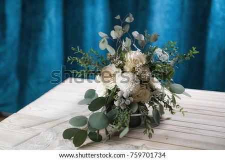 wedding bouquet of white roses, chrysanthemums, eucalyptus branches, brunia