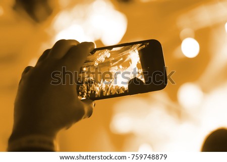 Video recording of the concert on the smartphone phone of the Beach or club party. Conceptual background of the youth party.