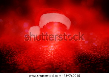 Red, abstract background with nice soft focus, shining lights and Santa's cap