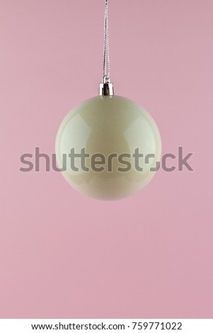 White christmas ball ornament on pink background. minimal concept idea