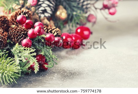New Year and Christmas background. Christmas frame with decoration, sprig of pine, cones and berries. Place for text. Selective focus