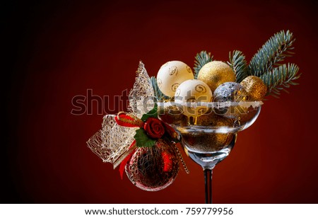 Christmas balls in wineglass on a dark background. Copy space .