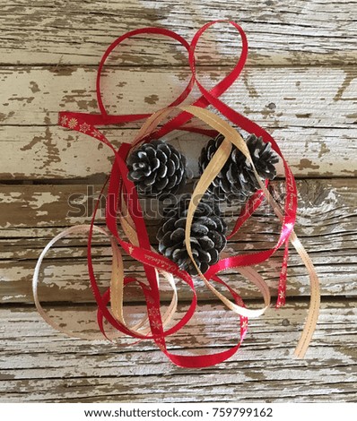 Christmas decoration hand made  with pine cones and ribbons on wood