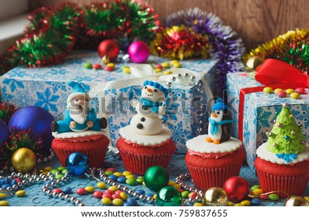 Christmas cupcakes with colored decorations made from confectionery mastic, soft focus background