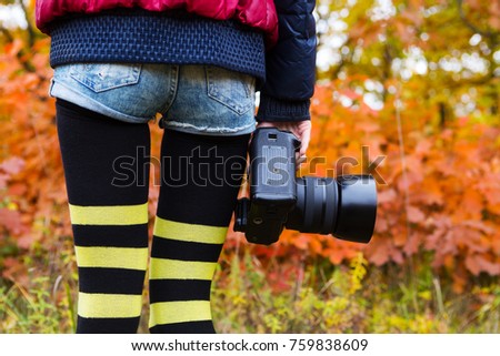 professional camera in girl's hand. Photographer on a background