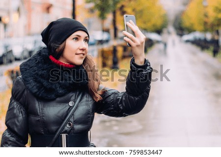Young woman taking selfie of herself outdoors