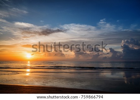 A picturesque sunset over a calm ocean. Phuket, Thailand