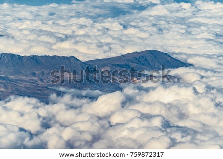 Aerial view from window plane of andes range mountains over chilean territory.