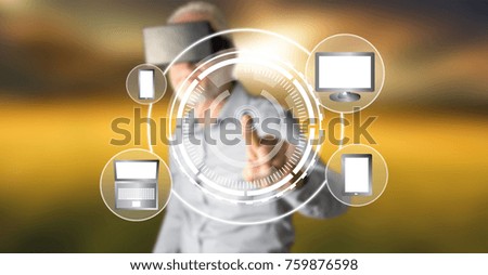 Man wearing a reality virtual headset touching a device connection concept on a touch screen with his finger