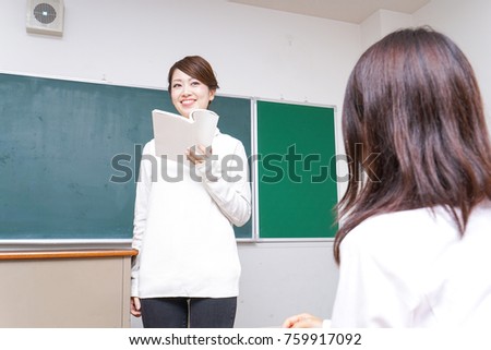 Female teacher having books giving lessons