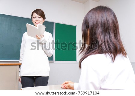 Female teacher having books giving lessons