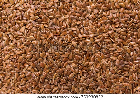 Linum usitatissimum is scientific name of Brown Flax seed. Also known as Linseed, Flaxseed and Common Flax. Closeup of grains, background use. Royalty-Free Stock Photo #759930832