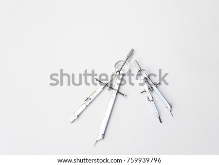 Pair of compasses set on white background