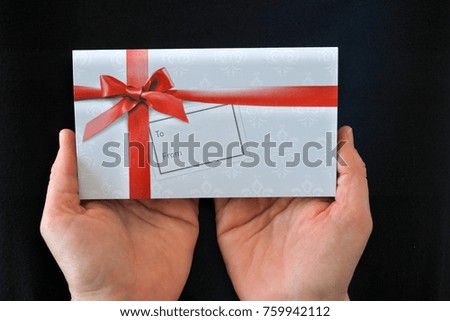 POV (point of view) of one adult woman hands holds a gift card. Holidays concept. Copy space.