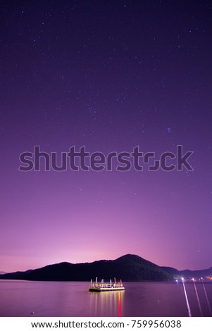 Beautiful Nightscape Of A Floating Deck With Starry Sky In The Background In Geoje Island, South Korea. Image Has Grain Or Blurry Or Noise Or Out Of Focus And Soft Focus When View At Full Resolution.