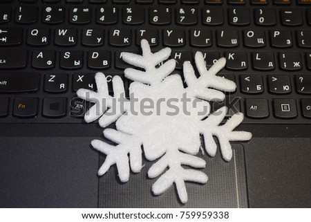 big christmas snowflake lies on the laptop keyboard