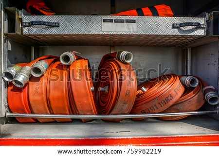 Rolled up red fire fighting hose