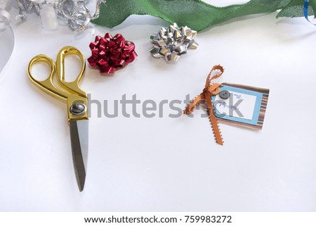 gift wrapping ribbon and scissors used to wrap presents at christmas time from top view