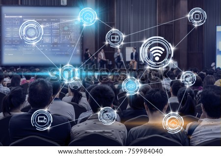 Wireless communication connecting of smart city Internet of Things Technology over Abstract blurred photo of conference hall or seminar room with attendee background, technology with education concept Royalty-Free Stock Photo #759984040