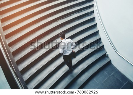 Businessman running fast upstairs Growth up Success concept Royalty-Free Stock Photo #760082926