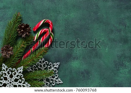New-year green background with sweets, snowflakes and cones. Happy New Year and Merry Christmas!