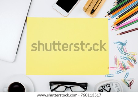 Top view of white office desktop with colorful supplies, device and other items. Copy space. Education and stationery concept