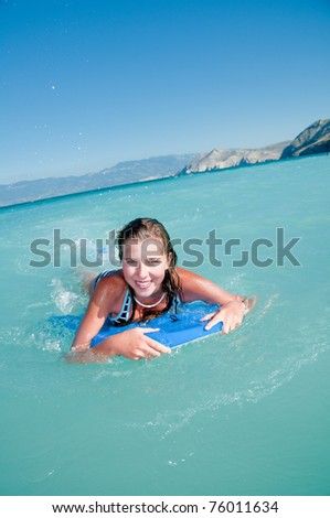 Bodysurfing - young girl surfing in the sea