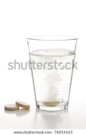 the effervescent tablets and glass with water