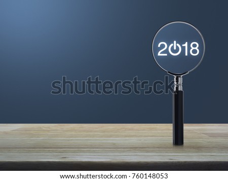2018 start up icon with magnifying glass on wooden table over light blue gradient background, Business happy new year 2018 concept