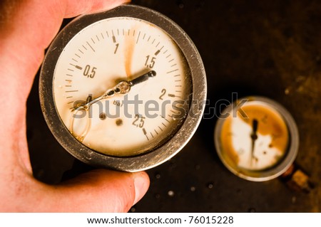 Pressure meter in hand with blurry background