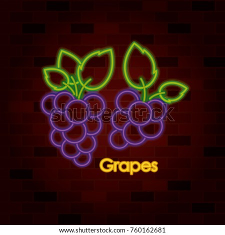 bunches of grapes on neon sign on brick wall