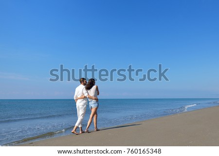 Beach couple walking on romantic travel honeymoon vacation summer holidays romance.