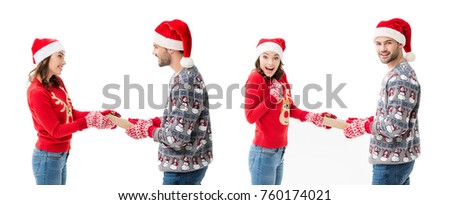young man and woman sharing christmas gifts to each other isolated on white