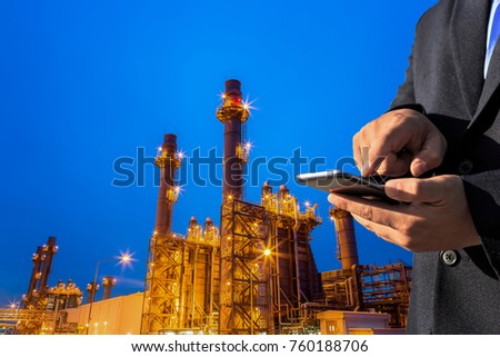 businessman use smart phone check gas turbine electric power plant