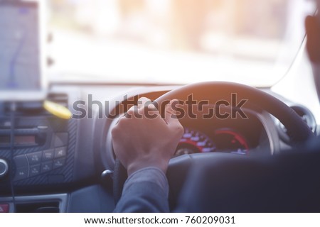 An unidentified man is driving Uber taxi. Image taken from back seat Royalty-Free Stock Photo #760209031