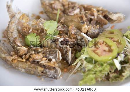 Deep Fried Fish with Garlic as a background or wallpaper.