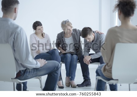 Psychotherapist supporting a man who lost his wife. Support group meeting for people in mourning Royalty-Free Stock Photo #760255843
