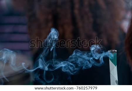 Close up scene of joss fragrant stick smoke in Asian temple
