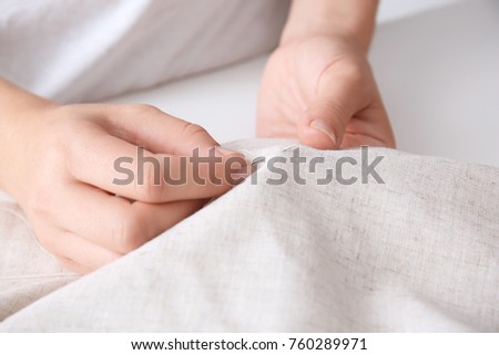 Woman sewing by hand, closeup Royalty-Free Stock Photo #760289971