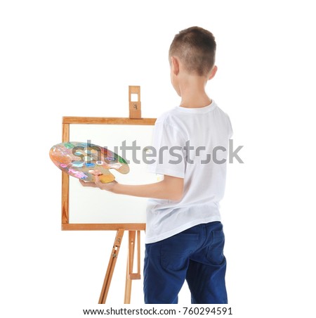 Cute little boy painting picture on canvas against white background