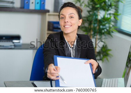 female worker give a contract to sign