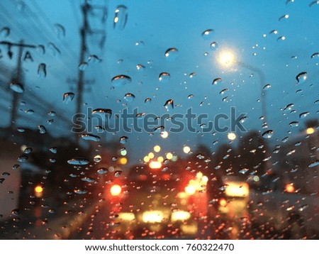 Blurred background, Raindrops on the windshield, street lights at night on a rainy day.