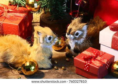 Two Squirrels and gift decorate under christmas tree for celebration christmas party. 