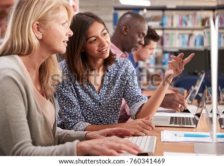 Mature Female Student With Tutor Learning Computer Skills Royalty-Free Stock Photo #760341469