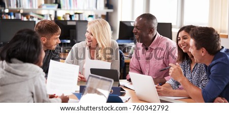 Group Of Mature College Students Collaborating On Project Royalty-Free Stock Photo #760342792