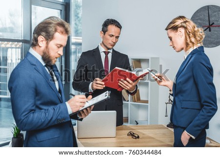 portrait of focused group of lawyers working in office
