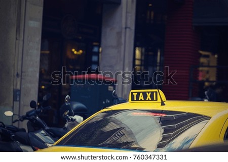 fragment of one yellow car of the taxi with the sign or with a symbol closeup and in the color photo in retro style