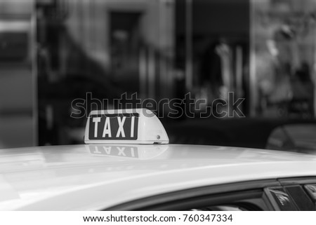 fragment of one car of the taxi with the sign or with a symbol and on the photo of monochrome tone
