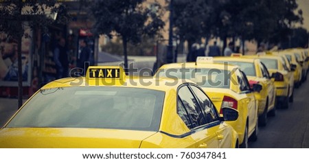 yellow cars of the taxi on the city street and on the color photo in retro style